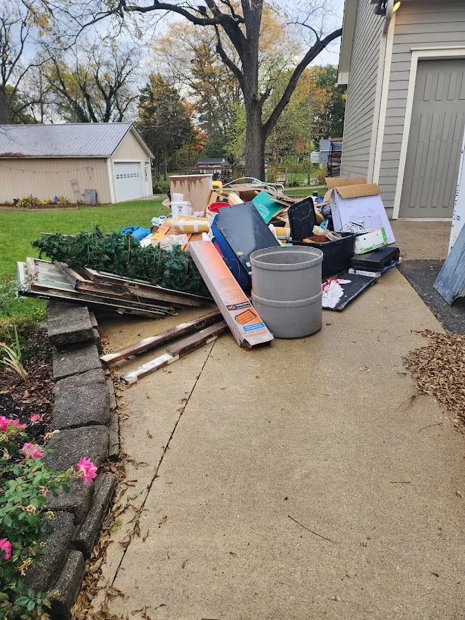 Dumpster being loaded with debris for Roofing Dumpster Rental in Altoona